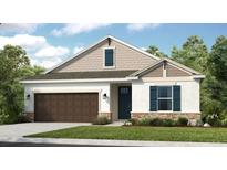 Charming one-story home with a two-car garage, stucco siding, shutters, and manicured landscaping at 545 Moon Shell Cir, New Smyrna Beach, FL 32168