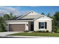Charming single-story home with a well-manicured lawn, two-car garage and attractive architectural details at 553 Moon Shell Cir, New Smyrna Beach, FL 32168