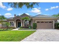 Charming home features a tile roof, manicured lawn and two car garage at 7672 Torino Ct, Orlando, FL 32835