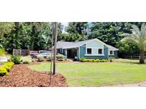 Charming single-story home with well-manicured lawn, fresh mulch beds and mature landscaping at 811 Fairview Ave, Altamonte Springs, FL 32701