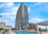 Modern high rise condo building with pool deck and clear blue skies in a desirable city location at 150 E Robinson St # 409, Orlando, FL 32801