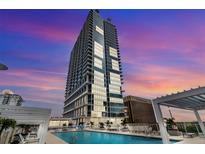 Luxury condominium rooftop pool with stunning city views and lounge seating, perfect for relaxation at 150 E Robinson St # 409, Orlando, FL 32801
