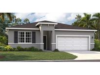 Charming single-story home featuring a manicured lawn, two-car garage, and neutral gray color palette at 415 Shoreview Sands Ave, Mascotte, FL 34753