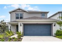 Charming two-story home with a well-manicured lawn and a two-car garage, creating an inviting curb appeal at 5329 Royal Point Ave, Kissimmee, FL 34746