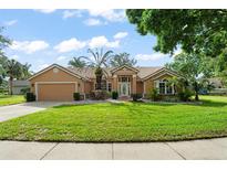 Charming single-story home with a well-manicured lawn and beautiful landscaping at 836 Copperfield Ter, Casselberry, FL 32707