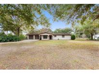 Charming single-story home with a two-car garage and a spacious front yard shaded by mature trees at 16336 Old Cheney Hwy, Orlando, FL 32833