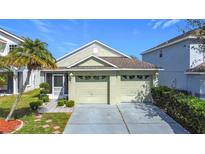 Charming single-story home features a two-car garage and well-maintained landscaping at 211 Southbridge Cir, Kissimmee, FL 34744