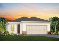 Charming single-story home with a well-manicured lawn and an attached two-car garage at 2334 Lily Bloom Rd, St Cloud, FL 34771