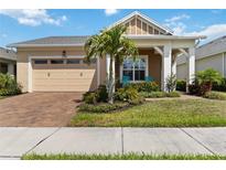 Charming home with a beige exterior, well-maintained landscaping, brick driveway, and a cozy porch area at 2789 Southland St, St Cloud, FL 34772