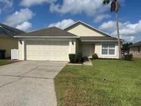 Charming single-story home with well-maintained lawn, and two car garage at 314 Casterton Cir, Davenport, FL 33897