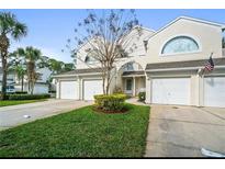 Inviting townhome with attached one-car garage, and well-manicured front lawn at 5999 Lake Pointe Dr # 602, Orlando, FL 32822