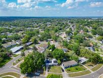 Expansive aerial view of a quiet neighborhood with lush trees, showcasing the property's peaceful surroundings at 106 Alhambra Ave, Altamonte Springs, FL 32714