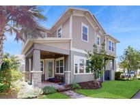 Charming two-story home with a covered front porch and beautifully landscaped yard at 13241 Cormack Ln, Orlando, FL 32827