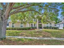 Charming home featuring a well-manicured lawn, lush landscaping, and a welcoming front entrance at 353 Meadow Beauty Ter, Sanford, FL 32771