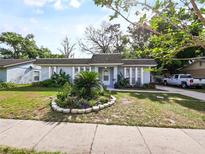 Charming single-story home with well-manicured landscaping and a classic facade with columns at 4025 Luan Dr, Orlando, FL 32808