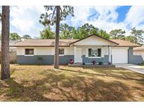 Charming single-story home featuring a brick-accented facade, a well-maintained lawn, and a cozy front porch at 4800 Beacon St, Orlando, FL 32808