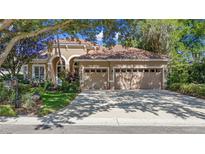 Beautiful one-story stucco home featuring a three-car garage and meticulously landscaped front yard at 1210 Pallister Ln, Lake Mary, FL 32746