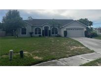 Charming single-story home featuring a well-maintained lawn and attached two-car garage at 2600 Cedar Bluff Ln, Ocoee, FL 34761