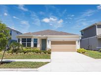 Charming single-Gathering home featuring a two-car garage and beautifully landscaped front yard at 4012 Meandering Bay Dr, Apopka, FL 32712