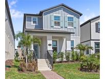 Charming two-story home featuring a well-manicured lawn, a welcoming porch, and a beautifully landscaped front yard at 12067 Eastmoor Dr, Winter Garden, FL 34787