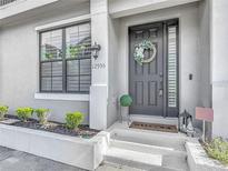Charming home exterior featuring a decorative wreath, manicured shrubs, and inviting entrance at 12955 Cats Claw Ln, Orlando, FL 32828