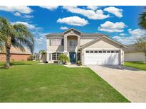 Charming two-story home with a well-manicured lawn and attached two car garage at 2315 Anhinga Dr, Kissimmee, FL 34743
