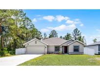 Charming single Gathering home with well-maintained lawn and attached two car garage at 236 Elm Ct, Kissimmee, FL 34759