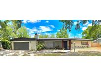 Charming single-story home with a spacious front yard and attached two-car garage at 605 Ensenada Dr, Orlando, FL 32825