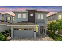 Charming two-story home with a well-manicured lawn and a modern architectural design at 7759 Westland Dr, Kissimmee, FL 34747
