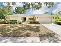 Charming single-story home with manicured landscaping and a welcoming two-car garage at 8506 Shady Glen Dr, Orlando, FL 32819