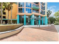 Inviting building entrance featuring modern design, colorful accents, and beautiful landscaping at 322 E Central Blvd # 1614, Orlando, FL 32801