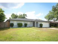 Charming single-story home with well-maintained lawn and attached garage at 7584 Lodge Pole Trl, Winter Park, FL 32792