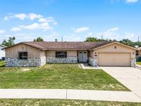 Inviting single-story house showcasing a well-kept front yard and neutral exterior paint at 1132 Feather Dr, Deltona, FL 32725