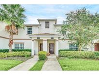 Inviting townhouse exterior featuring landscaped front yard and well-maintained facade at 1571 Plunker Dr, Davenport, FL 33896