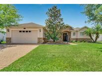 Charming single-story home with a lush green lawn, stone accents, and a welcoming front porch at 972 Bighorn St, Oviedo, FL 32765