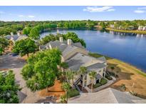 Beautiful waterfront condo building with lush landscaping and stunning lake views at 1065 S Hiawassee Rd # 1436, Orlando, FL 32835