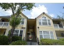 Inviting multi-story condo building with manicured landscaping and well-maintained facade at 1075 S Hiawassee Rd # 916, Orlando, FL 32835