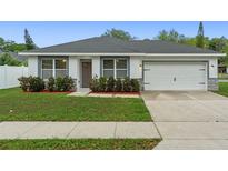 Charming single-story home with a well-maintained lawn, landscaping, and a two-car garage at 1440 Lake Shore Dr, Casselberry, FL 32707