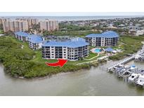 Beautiful aerial view of condo buildings with waterfront access and community pool at 2700 N Peninsula Ave # 314, New Smyrna Beach, FL 32169