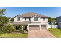 Beautiful two-story home featuring a brick driveway and well-manicured lawn at 3556 Cheswick Dr, Ocoee, FL 34761