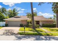 Inviting single-story home with a two-car garage, brick accents, and well-maintained landscaping at 400 Woodview Dr, Longwood, FL 32779