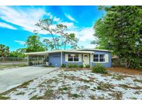 Charming single-story home with a carport, well-maintained landscaping, and a freshly painted exterior at 411 Hibiscus Rd, Casselberry, FL 32707