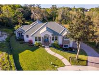 Beautiful single story home with well maintained landscaping and walkway leading to a double door entrance at 516 Sanctuary Golf Pl, Apopka, FL 32712