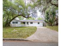 Charming single-story home with a long driveway and beautiful mature trees at 633 Hermits Trail, Altamonte Springs, FL 32701
