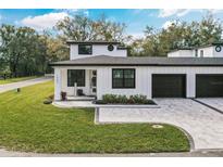 Charming two-story home with a paved driveway, well-manicured lawn and a two car garage at 1000 Farmstead St, Eustis, FL 32736