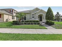 Charming single-story home featuring a beautifully landscaped front yard with manicured bushes and a paver walkway at 16892 Hypatia Aly, Winter Garden, FL 34787