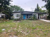 Charming single-story home featuring a neatly maintained yard and a welcoming blue front door at 2838 Wright Ave, Winter Park, FL 32789