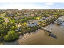 Charming waterfront home featuring a private dock, lush landscaping, and scenic views at 3216 John Anderson Dr, Ormond Beach, FL 32176