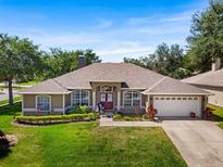 Charming single-story home featuring a well-manicured lawn and a two-car garage at 901 Cornell Ave, Clermont, FL 34711