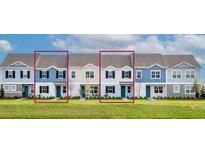 Charming two-story townhome featuring a colorful facade, complemented by well-manicured landscaping at 1476 Silver Lining Way, Apopka, FL 32703